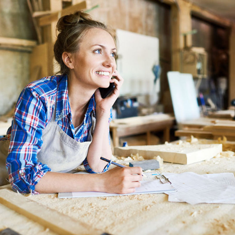 Portrait of Cheerful Carpenter with Smartphone